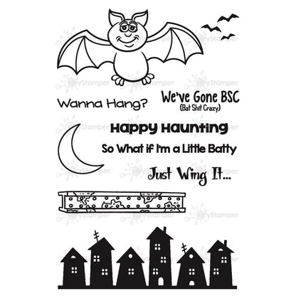 Halloween-themed rubber stamp set with bat, moon, and haunted houses on a white background.
