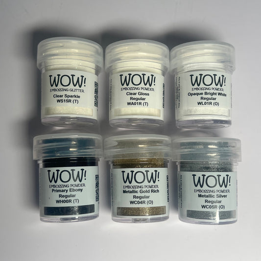Six jars of WOW! Embossing Powder on a gray background