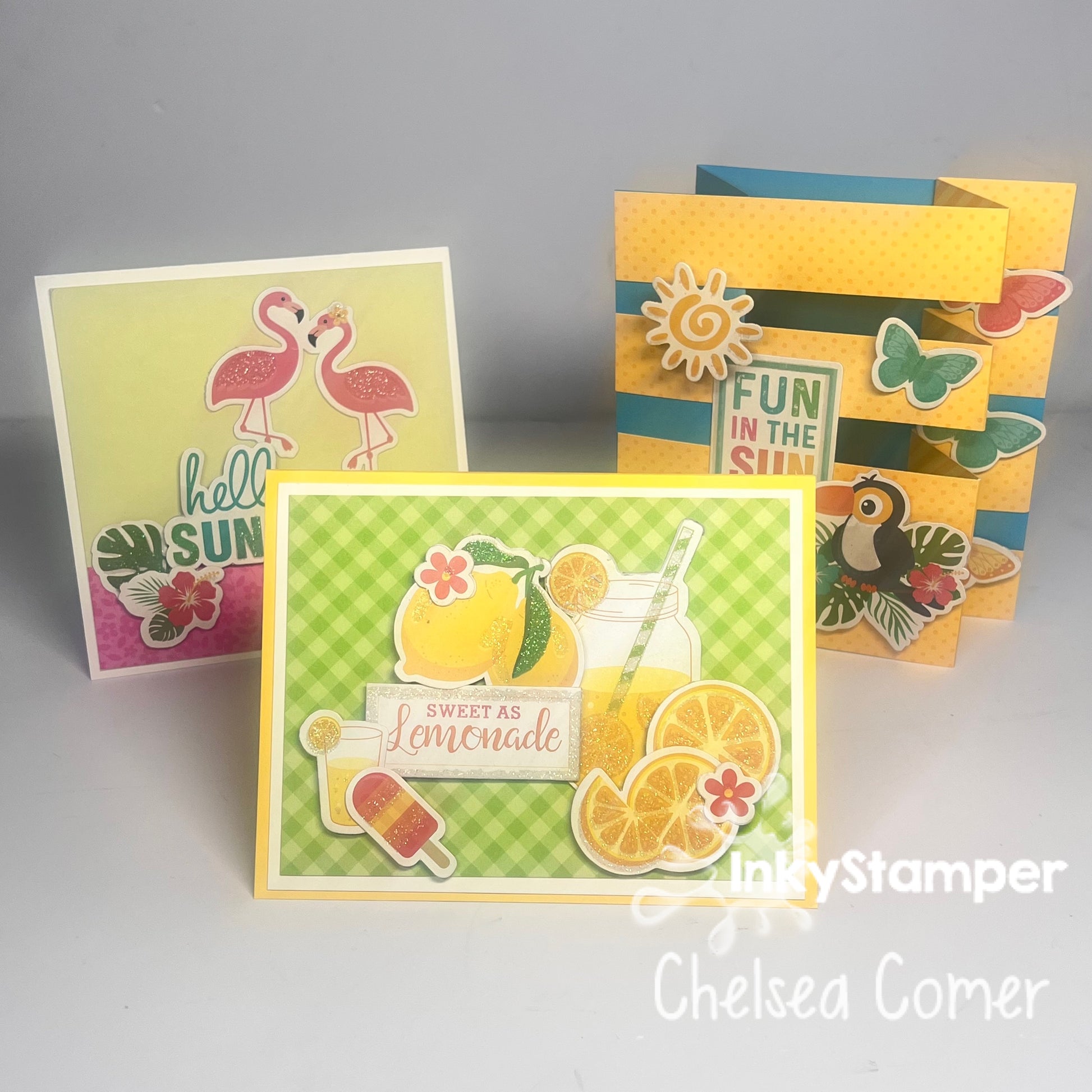 InkyStamper SMC kit for Saturday Morning Crafting.  Three colorful greeting cards with summer-themed designs on a gray background.