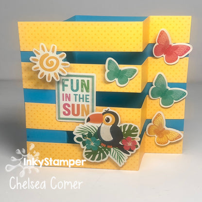 Colorful card with tropical elements and 'Fun in the Sun' text, featuring a toucan, butterflies, and sun design.  Part of InkyStamper SMC Saturday Morning Crafting